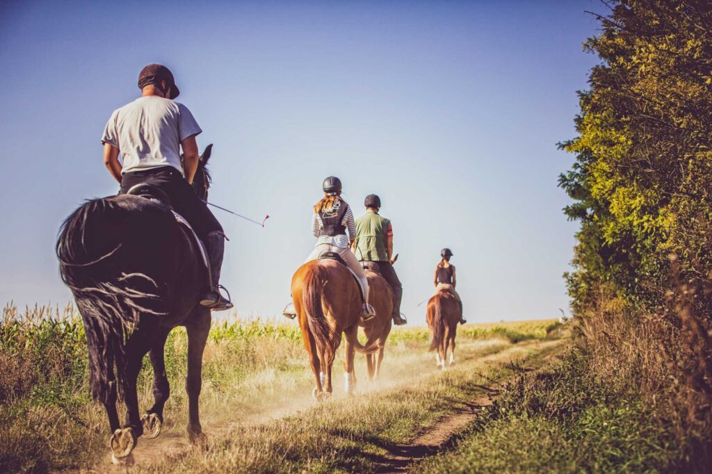 Group of students with riding instructor on a rural path